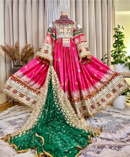 Long ceremonial dress in Golabi color with Sekka-dozi and Charmadozi on chest, skirt, and sleeves, Morra-dozi on shoulders. Comes with green Indian shal and Golabi crepe shalwar. Free size (EU 36–42), length 145 cm.