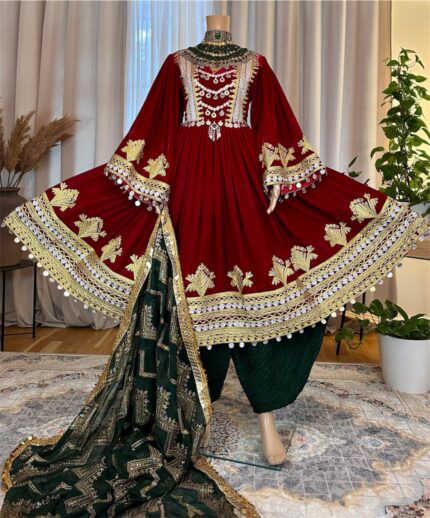 Maroon Makhmal dress with Charmadozi on chest, skirt, and sleeves. Comes with green Gaj shal and green Gibi shalwar. Free size (EU 36–42)