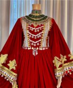 Maroon Makhmal dress with Charmadozi on chest, skirt, and sleeves. Comes with green Gaj shal and green Gibi shalwar. Free size (EU 36–42)
